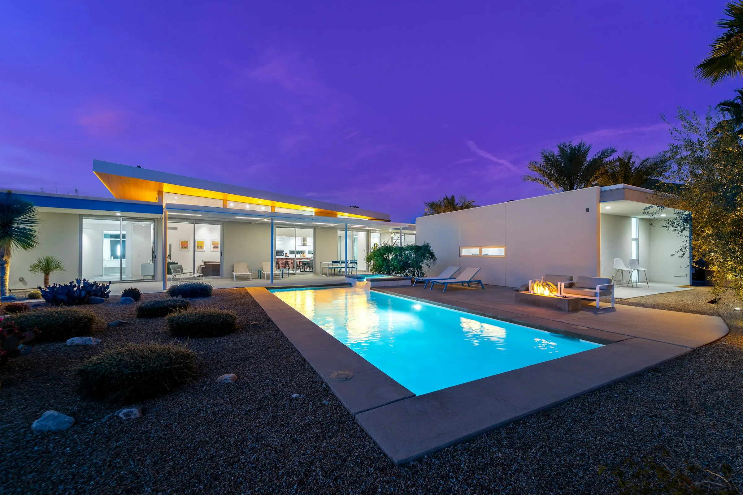 Modern residence with a pool at dusk